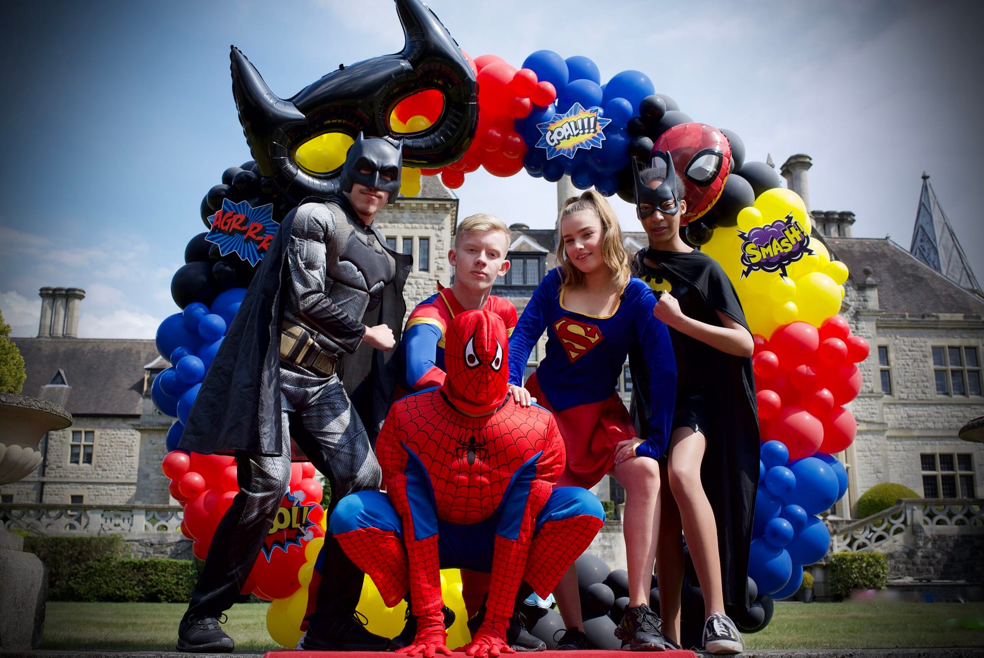 Superhero themed birthday balloons and character dress up