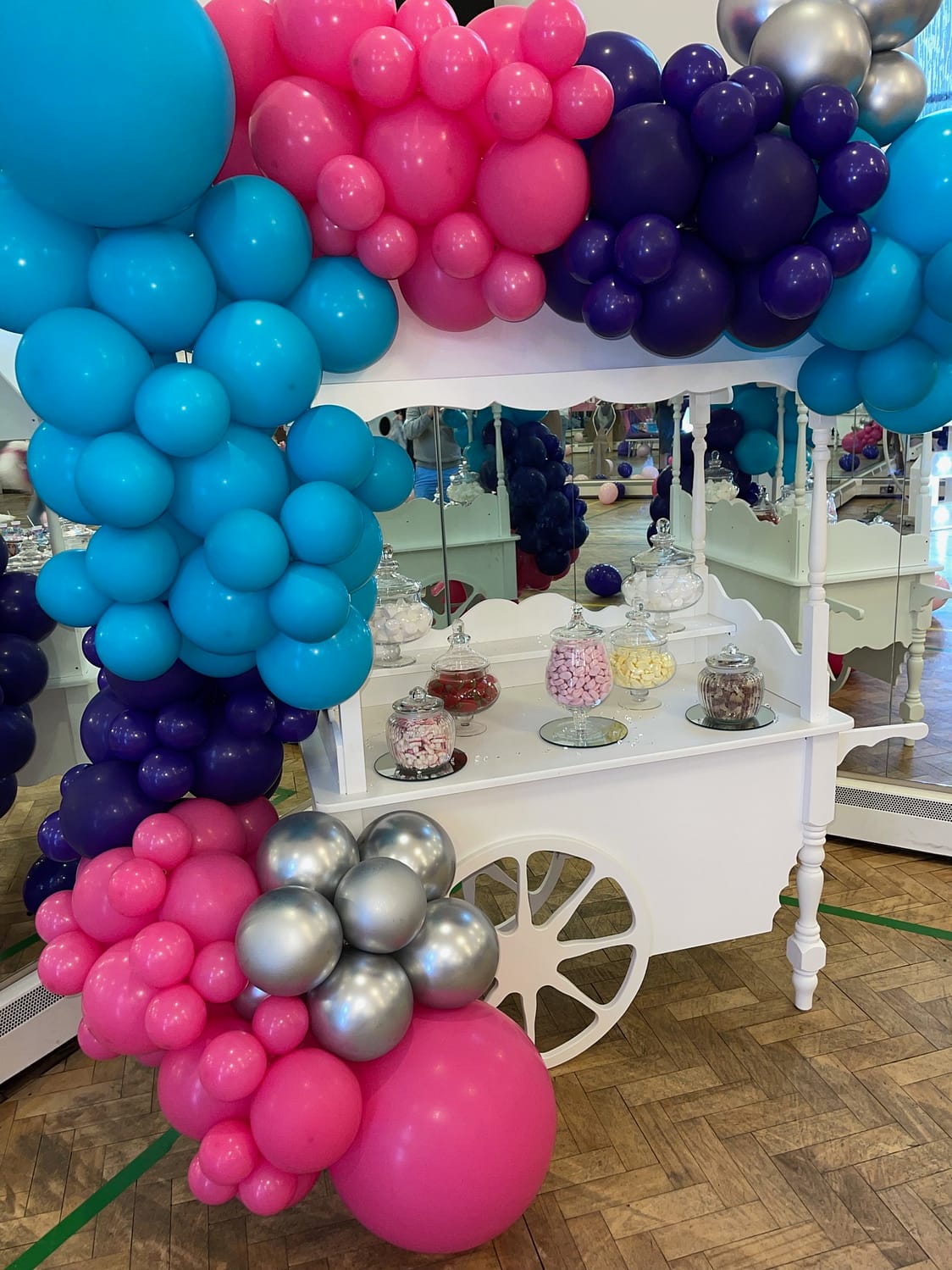 Sweet cart with blue, pink, purple and silver balloons