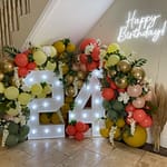 24 light up numbers with balloons, flowers and Happy Birthday neon light