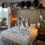 Hotel room decorated with number 30 balloons 2