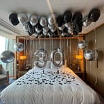 Hotel room decorated with number 30 balloons