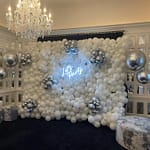 Lets Party neon light with white balloons