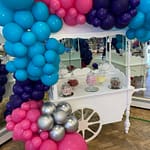 Sweet cart with blue, pink, purple and silver balloons
